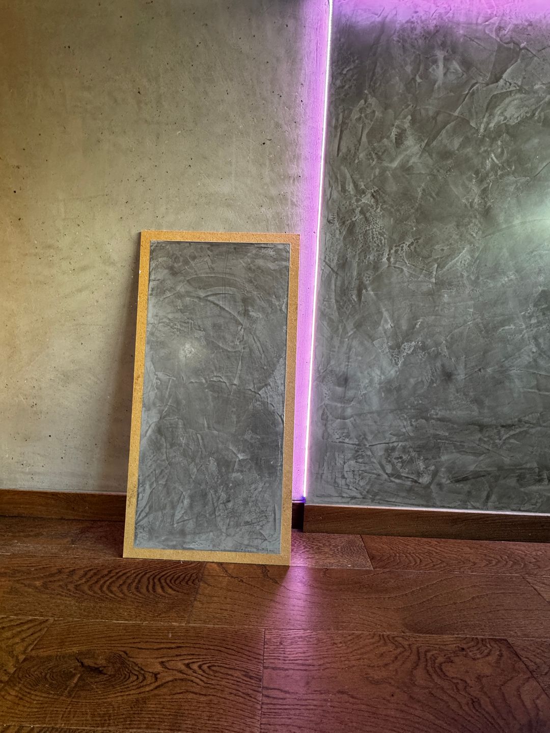 Textured heated wall in the yoga room, with a sample panel set in front