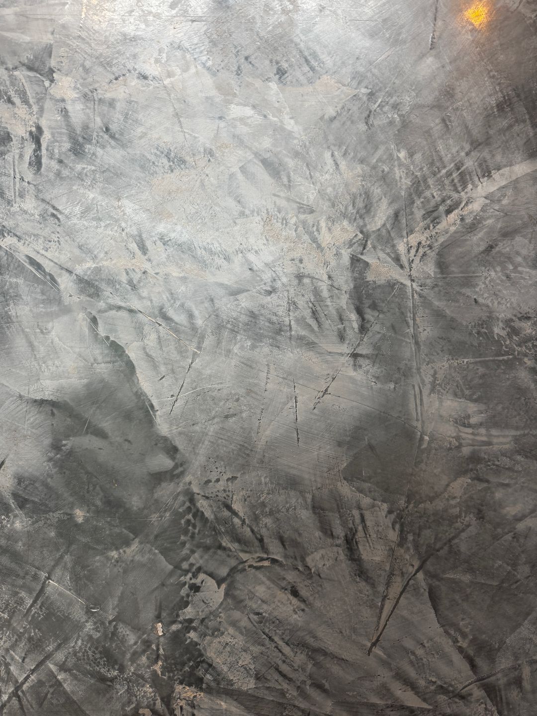 Close-up of grey Spatula Stucchi showing the hand-worked trowel marks