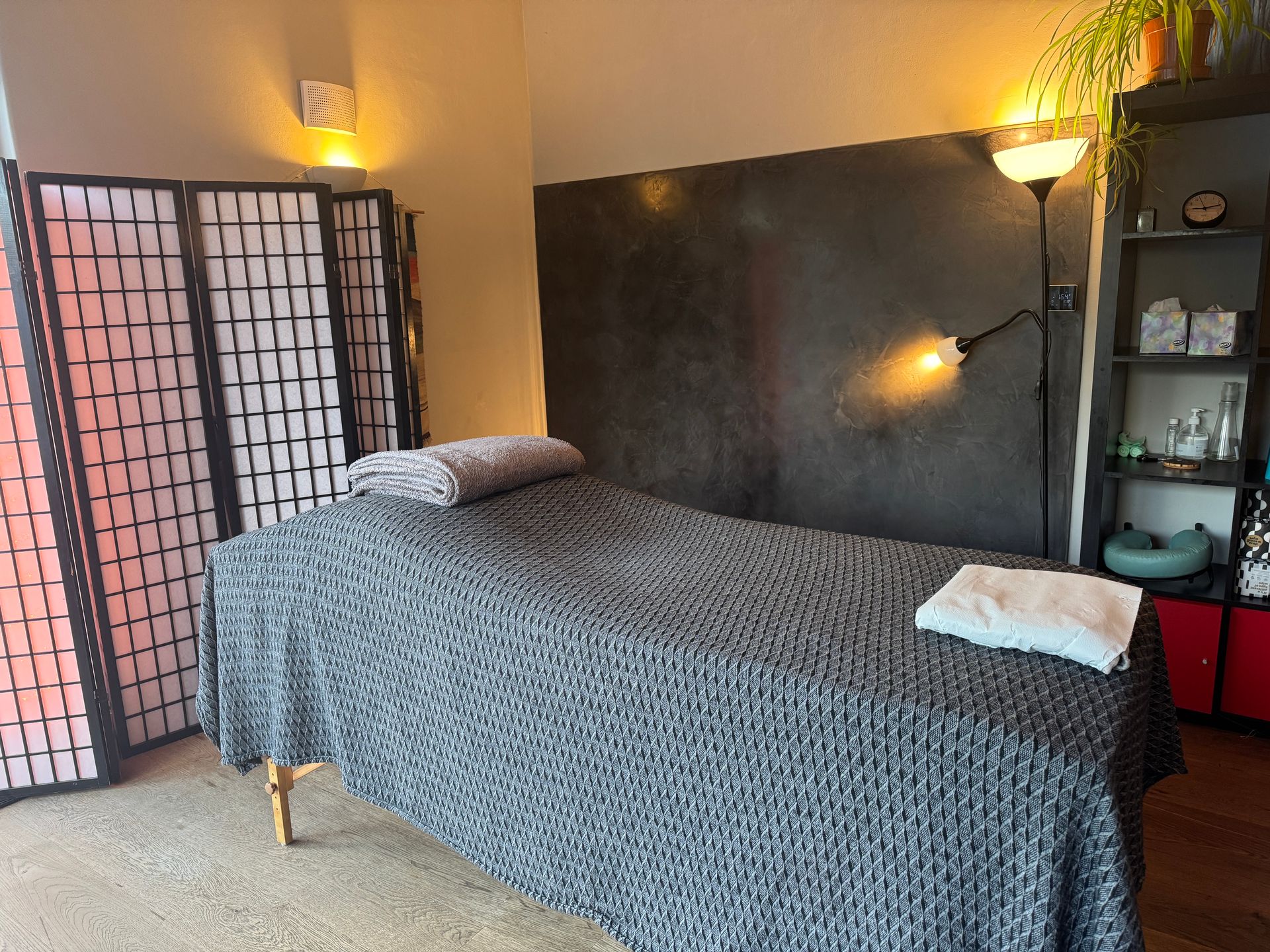 Finished dark plaster wall in a furnished room with warm lighting